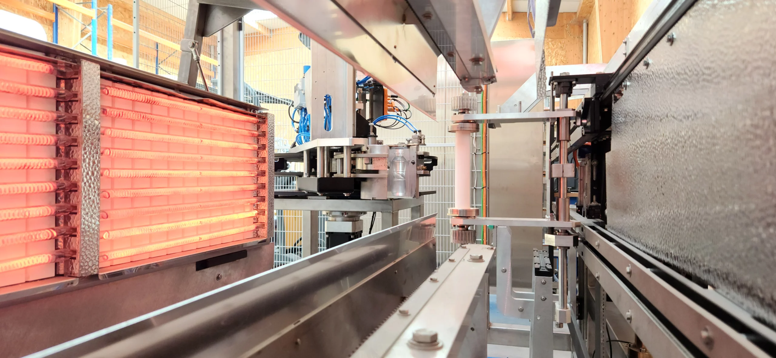 Close-up of Ublo’s Roll-to-Bottle machine heating and forming unit